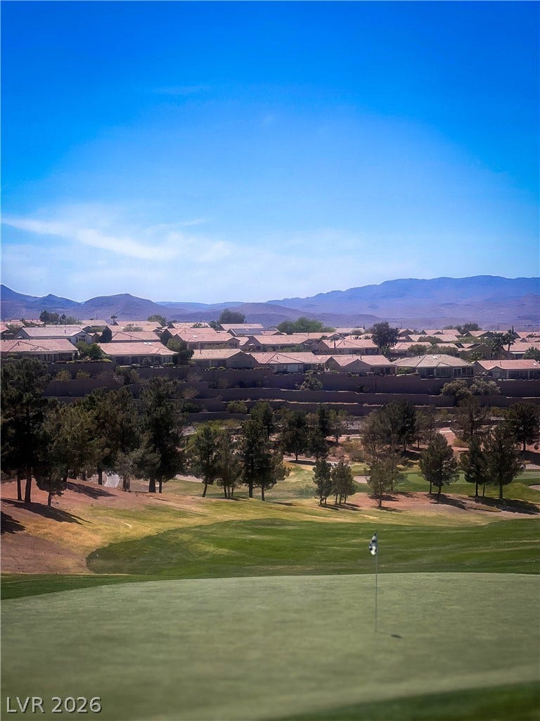 2157 Sawtooth Mountain Drive, Henderson, NV 89044 A well-maintained golf course with residential properties nestled in the hills.