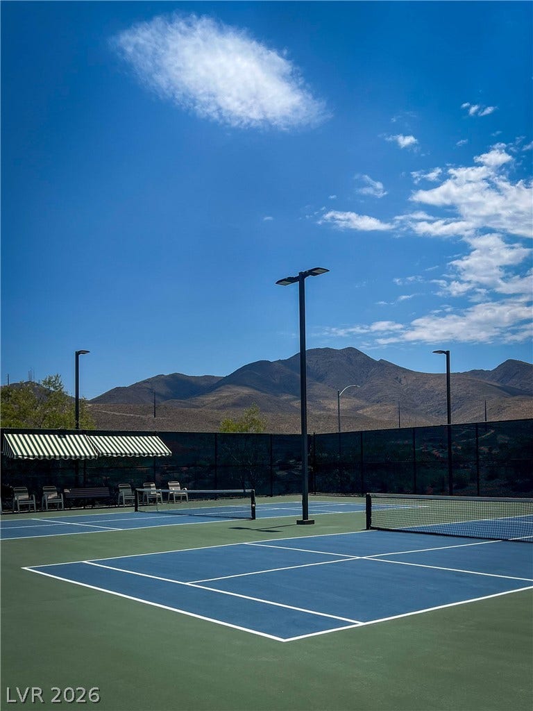 2157 Sawtooth Mountain Drive, Henderson, NV 89044 Tennis courts and pickle ball courts await for competitive play, backed by a scenic mountain landscape.