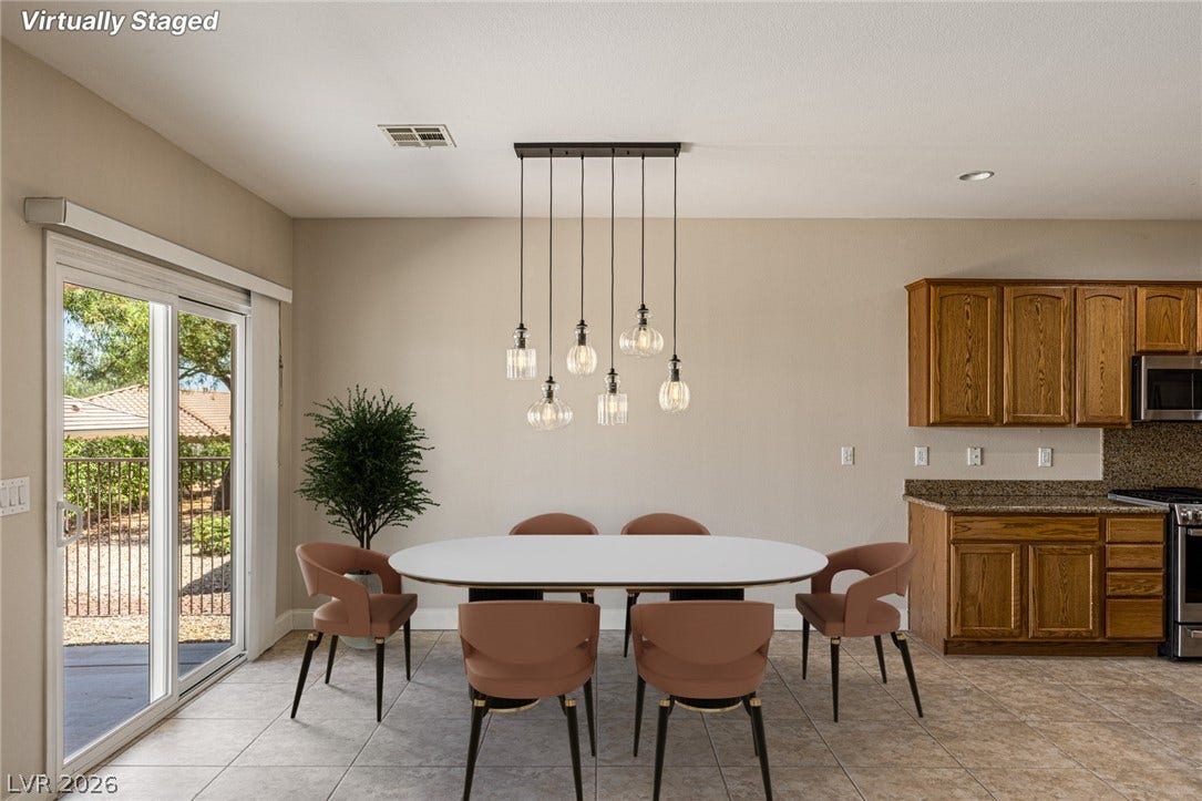 2157 Sawtooth Mountain Drive, Henderson, NV 89044 Sliding glass doors offer an abundance of natural light to this appealing dining area.