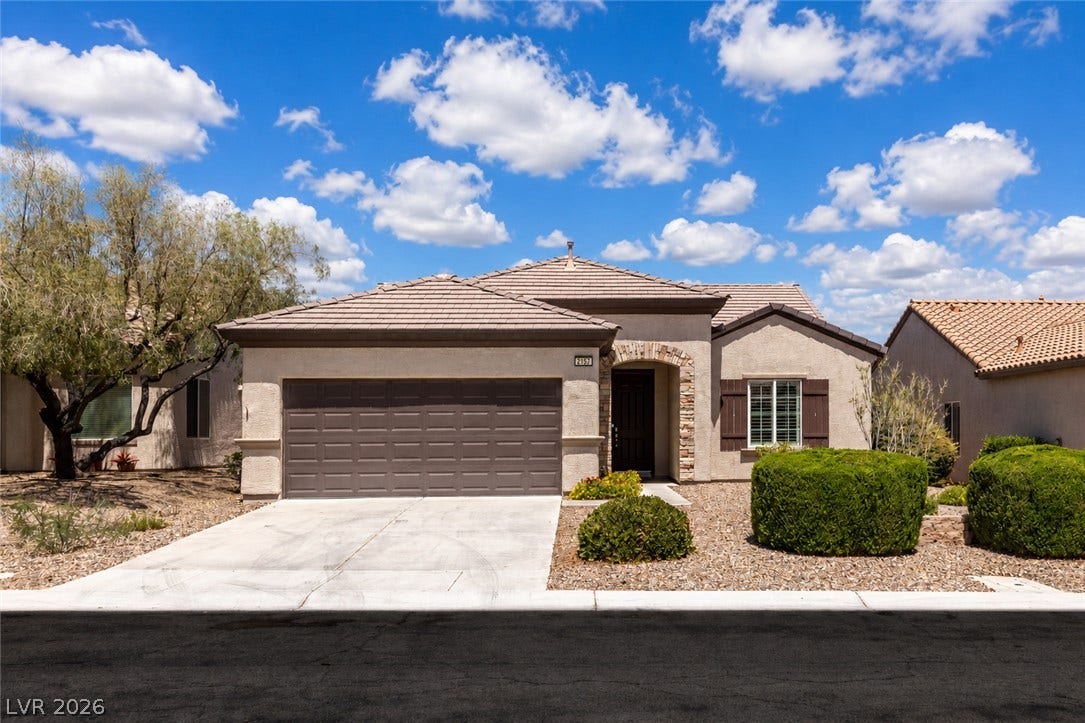 2157 Sawtooth Mountain Drive, Henderson, NV 89044 A well-maintained stucco home with a tile roof and attached garage, offering charming curb appeal.