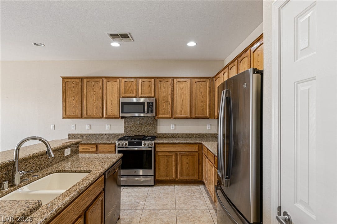 2157 Sawtooth Mountain Drive, Henderson, NV 89044 A well-appointed culinary space featuring ample cabinetry and included stainless steel appliances.