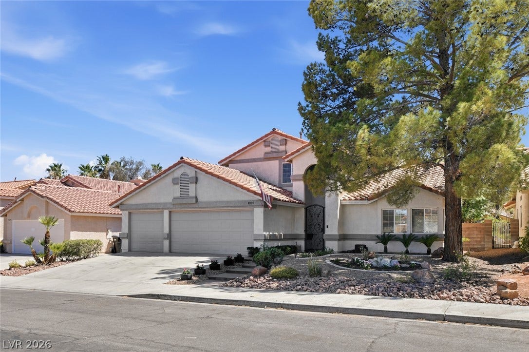 1827 Escondido Terrace, Henderson, NV 89074 An inviting exterior with a manicured desert-style landscape and a dual-garage entry.