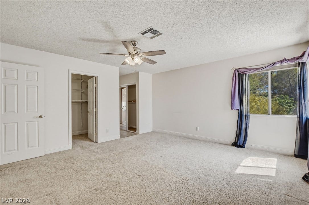 1827 Escondido Terrace, Henderson, NV 89074 A quiet bedroom with plush carpeting and ample natural light offers a tranquil retreat.