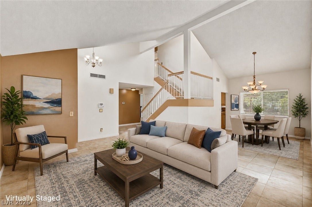 1827 Escondido Terrace, Henderson, NV 89074 Enter a well-lit living area with vaulted ceilings and a seamless flow to the dining space, featuring tiled flooring.