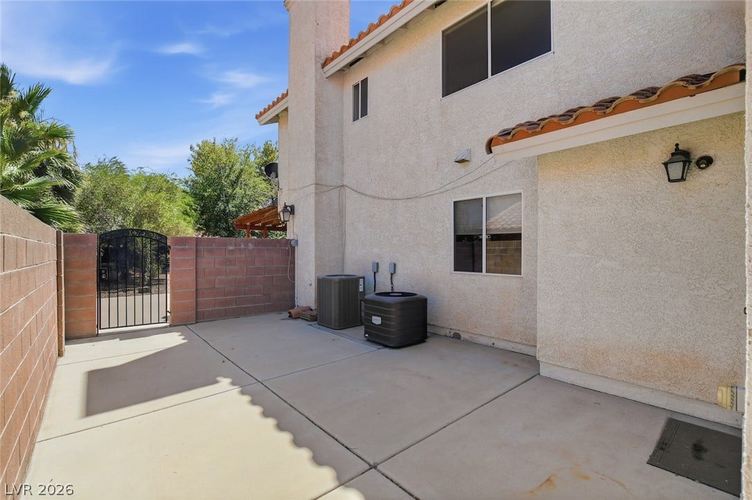 1827 Escondido Terrace, Henderson, NV 89074 A spacious, enclosed side yard features concrete paving and a decorative iron gate.