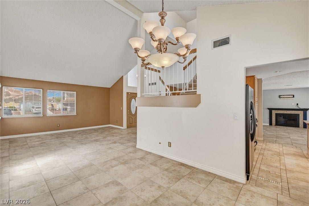 1827 Escondido Terrace, Henderson, NV 89074 A grand chandelier illuminates the spacious living area with vaulted ceilings and ceramic tile flooring.