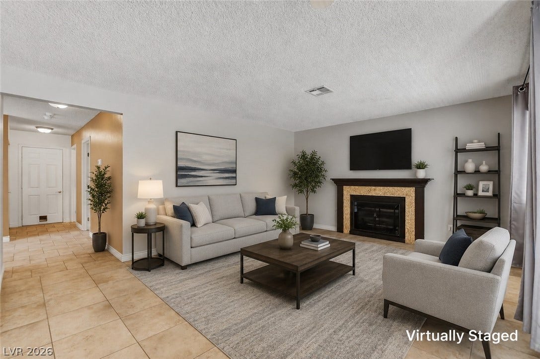 1827 Escondido Terrace, Henderson, NV 89074 A refined fireplace and tile flooring anchor this comfortably appointed living area.