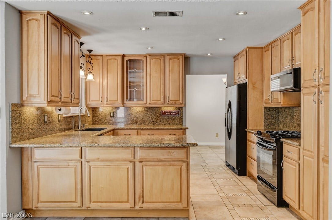 1827 Escondido Terrace, Henderson, NV 89074 A well-appointed culinary space featuring extensive cabinetry and essential modern appliances.