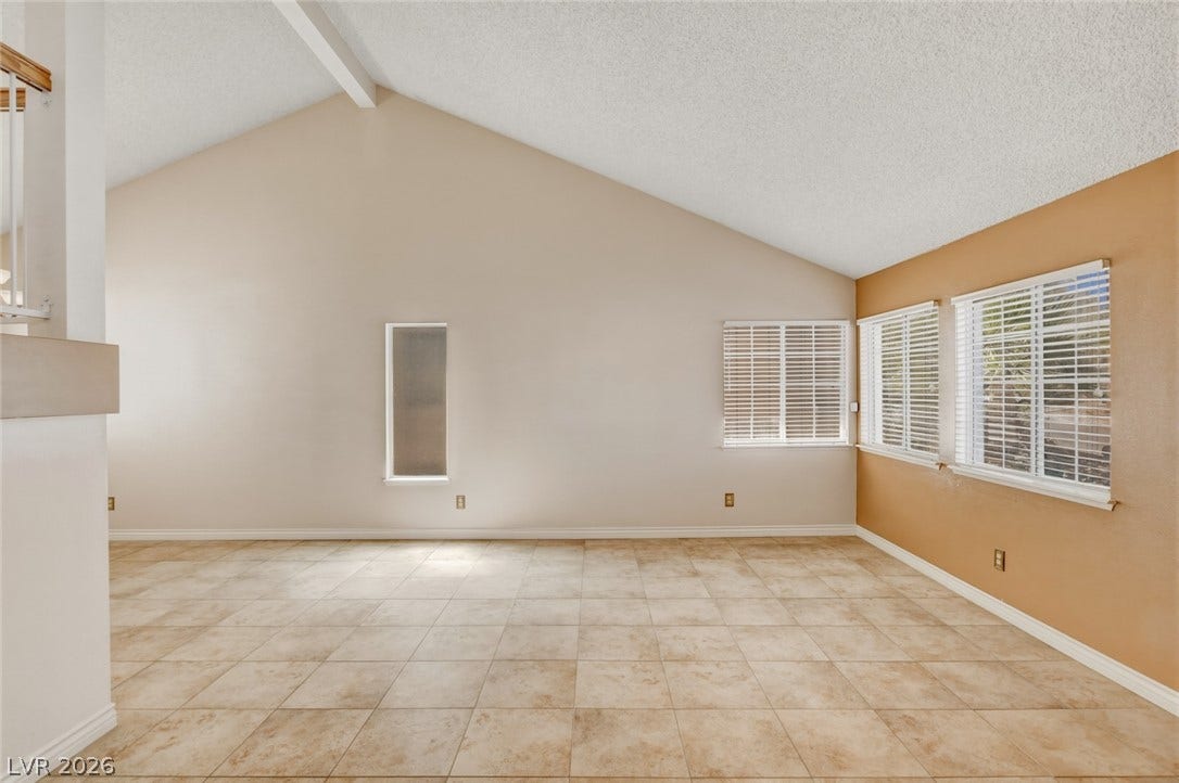 1827 Escondido Terrace, Henderson, NV 89074 A spacious living area features high vaulted ceilings and light-toned tile flooring.