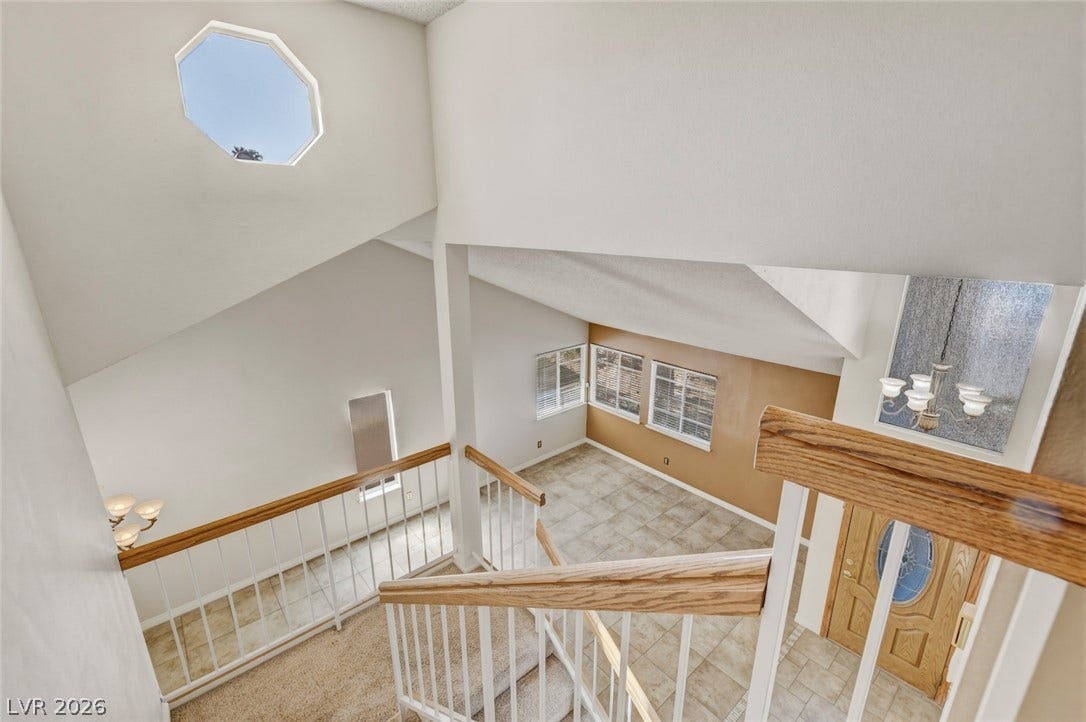 1827 Escondido Terrace, Henderson, NV 89074 Natural light pours in from an octagonal skylight, illuminating the architectural lines of this home's soaring ceilings and staircase.