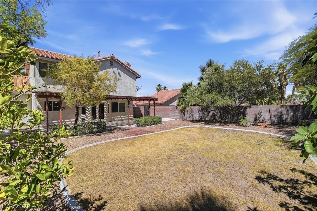 1827 Escondido Terrace, Henderson, NV 89074 A spacious yard with mature landscaping offers a serene outdoor retreat.