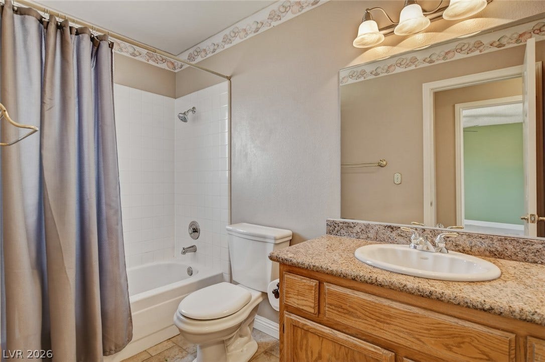 1827 Escondido Terrace, Henderson, NV 89074 Functional bathroom featuring a tub-shower combination, a vanity with ample counter space, and a large mirror.