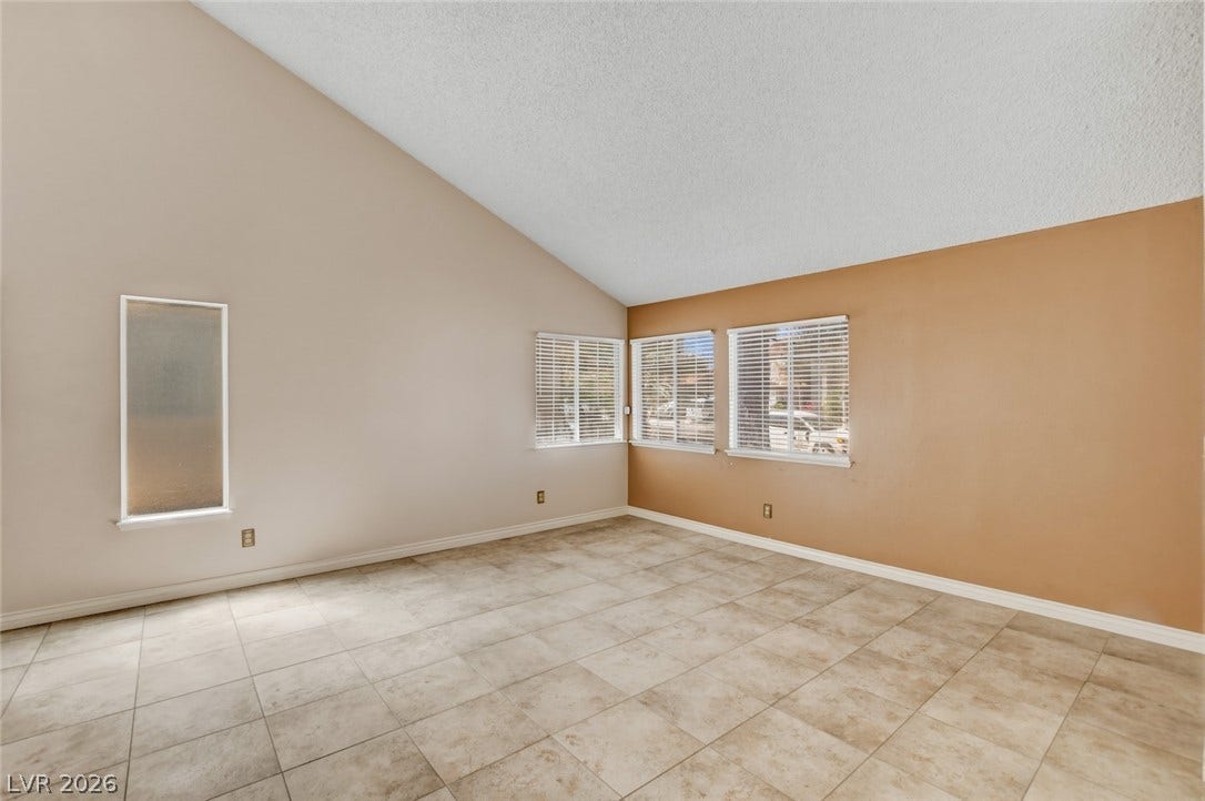 1827 Escondido Terrace, Henderson, NV 89074 A well-lit living area features an impressive vaulted ceiling and durable tile flooring.