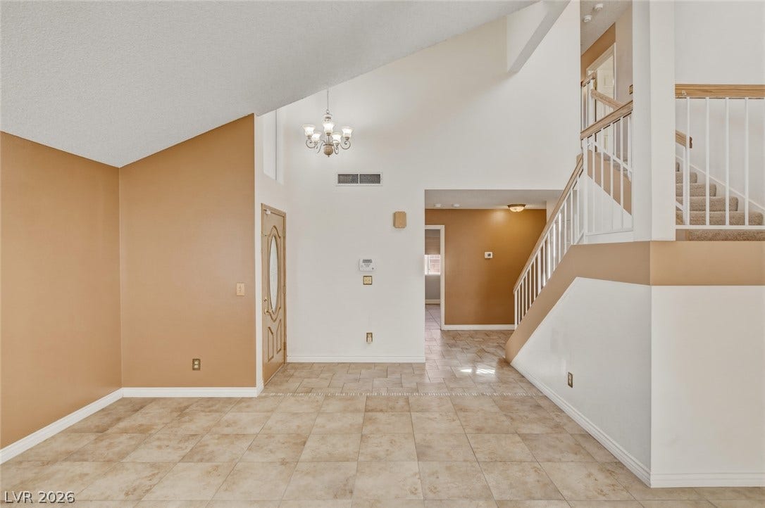 1827 Escondido Terrace, Henderson, NV 89074 Enter into a vast living space featuring high vaulted ceilings and a grand staircase.