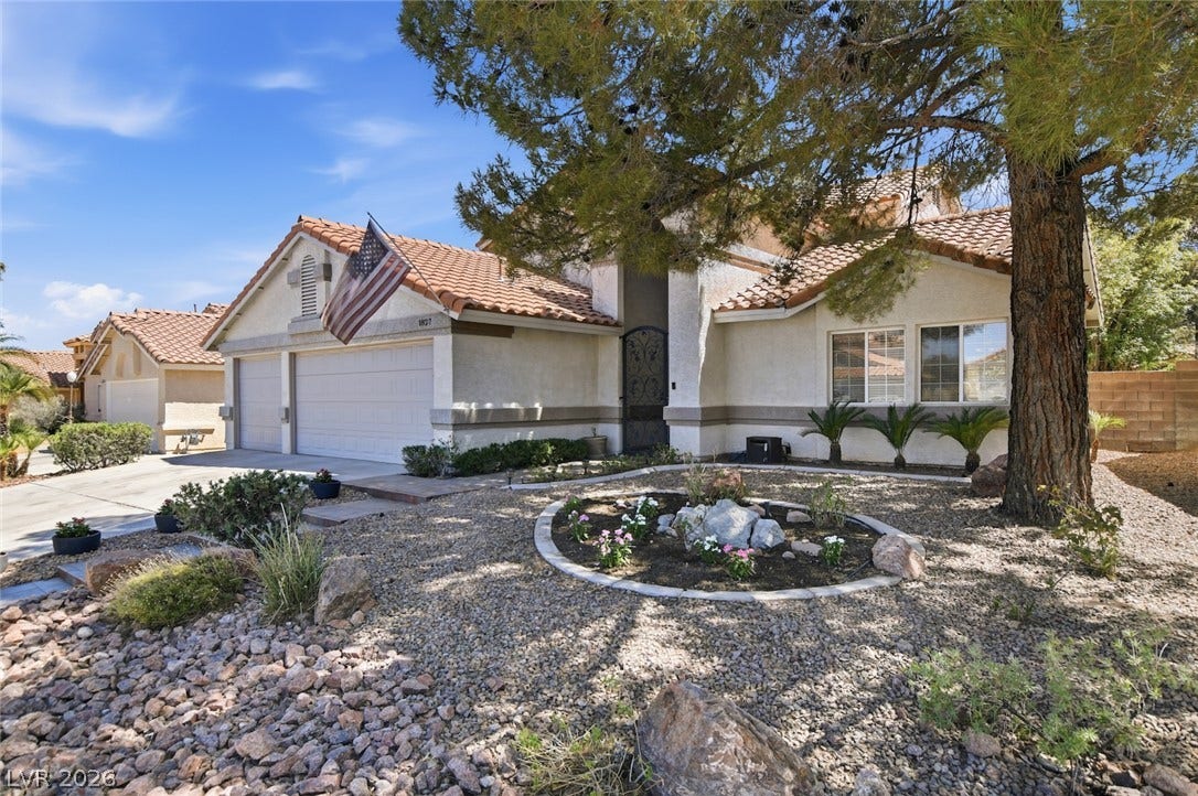 1827 Escondido Terrace, Henderson, NV 89074 A well-maintained desert landscape frames this welcoming stucco residence, featuring a two-car garage and a tile roof.