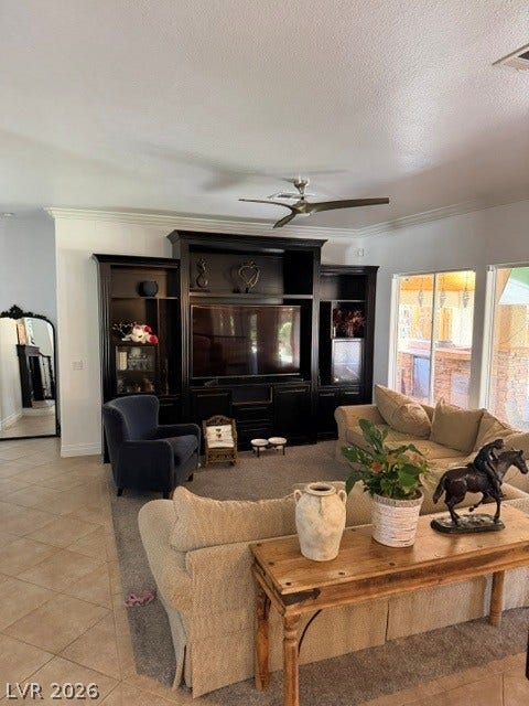 699 Brandy Hill Place, Henderson, NV 89052 An inviting family room showcasing a large media center and comfortable seating, ideal for gathering.