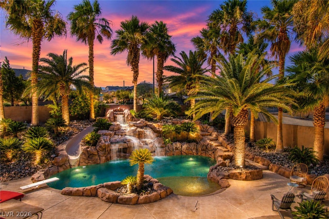 699 Brandy Hill Place, Henderson, NV 89052 An oasis of tranquility awaits with a rock waterfall and lush landscaping surrounding the custom pool.