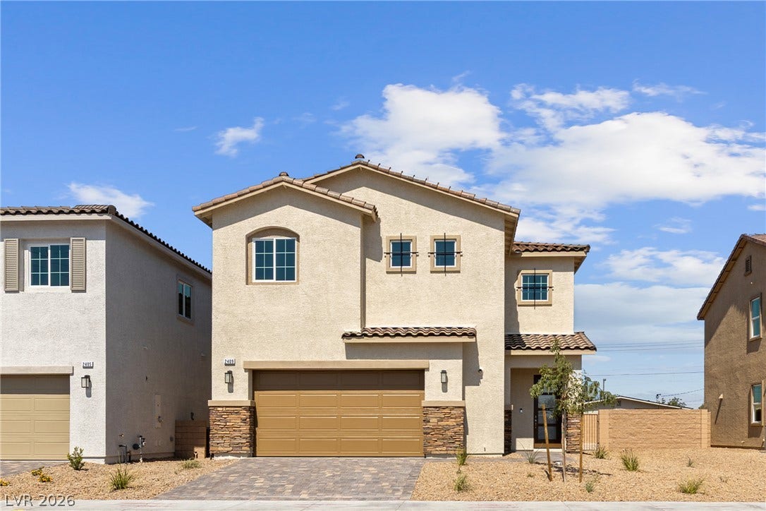 Spanish tile roofing and stone veneer details elevate this two-story stucco exterior design.