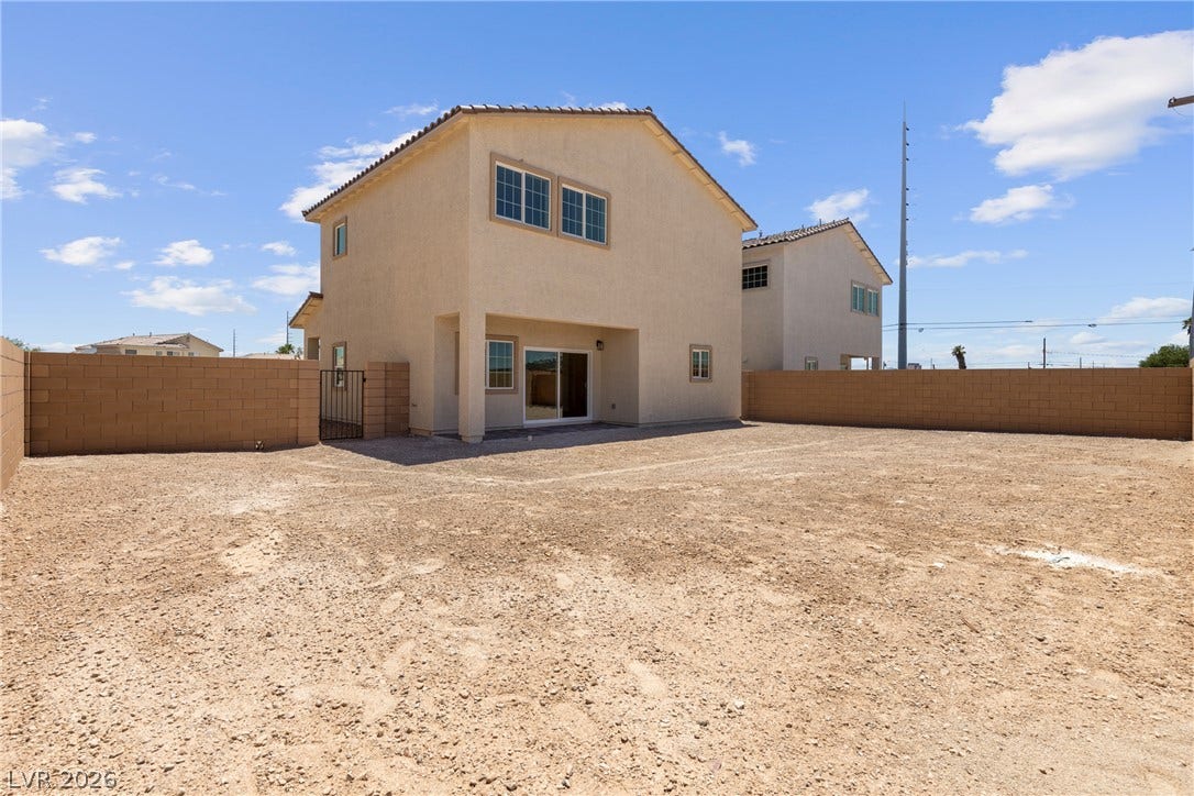 An expansive backyard space surrounded by privacy block walls awaits personalized landscaping designs.