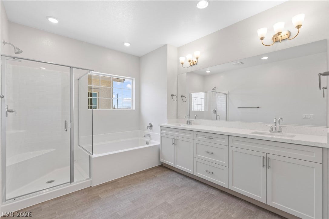 Clean lines and a spacious dual vanity define this modern master bath layout.