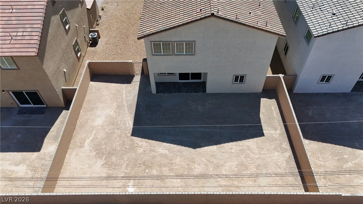 An enclosed backyard provides a blank canvas ready for custom landscaping and outdoor design.