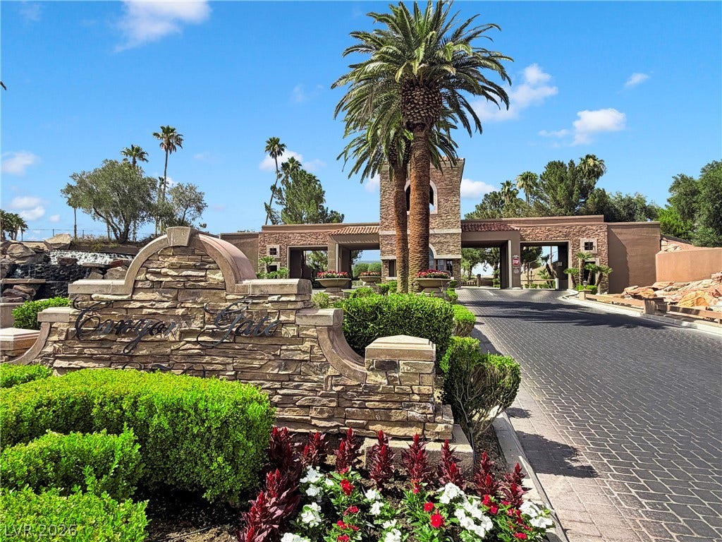 8921 Diamond Falls Drive, Las Vegas, NV 89117 Enter through the welcoming stone-clad gate, framed by lush landscaping and soaring palm trees.
