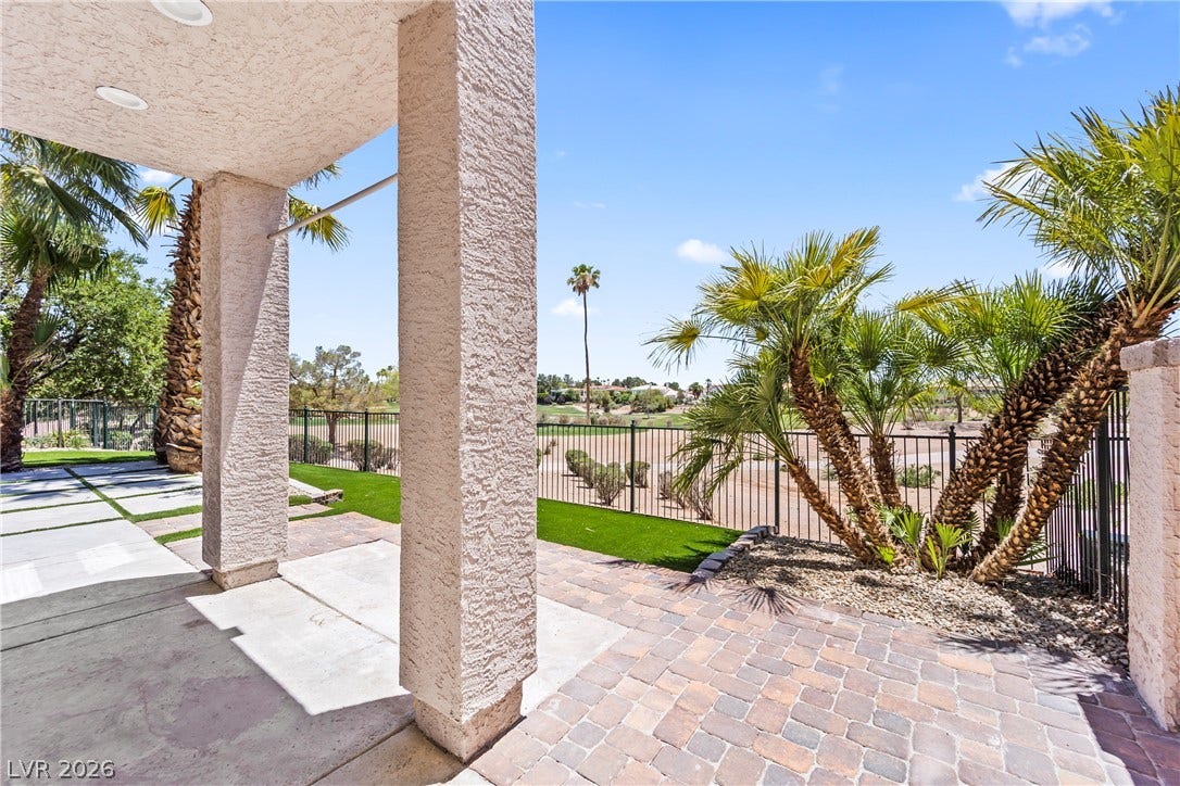 8921 Diamond Falls Drive, Las Vegas, NV 89117 A spacious covered patio with pavers overlooks a golf course and a well-maintained yard.