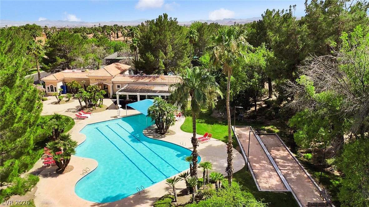 8921 Diamond Falls Drive, Las Vegas, NV 89117 An inviting pool and recreational area, surrounded by verdant landscaping, promises endless leisure.