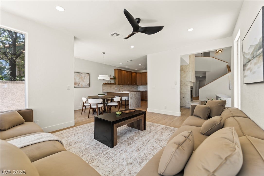 8921 Diamond Falls Drive, Las Vegas, NV 89117 Bright, airy living area flows seamlessly into the kitchen and dining space, all bathed in natural light.