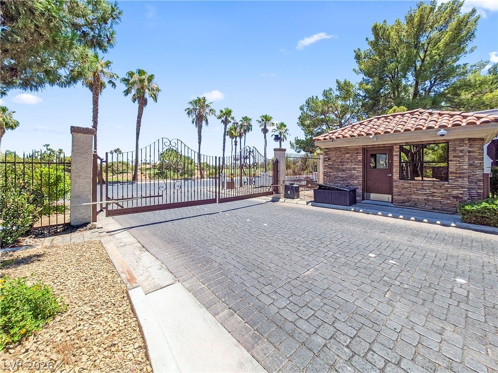 8921 Diamond Falls Drive, Las Vegas, NV 89117 Secure community entrance with an elegant gated entry and a welcoming guardhouse.