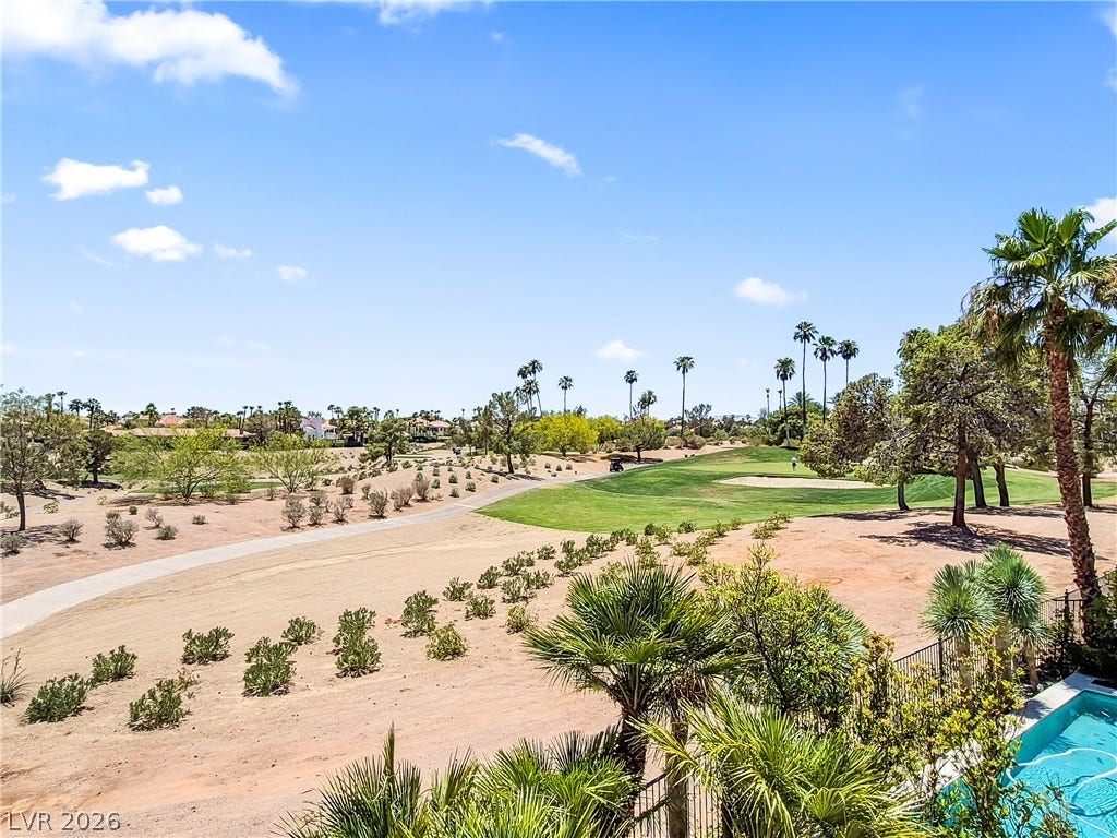 8921 Diamond Falls Drive, Las Vegas, NV 89117 A pristine golf course green against a desert landscape offers scenic recreation.
