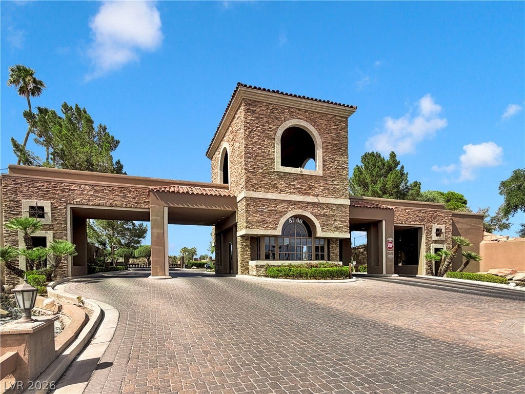 8921 Diamond Falls Drive, Las Vegas, NV 89117 A grand gated entrance featuring stone and stucco architecture welcomes residents to this exclusive community.