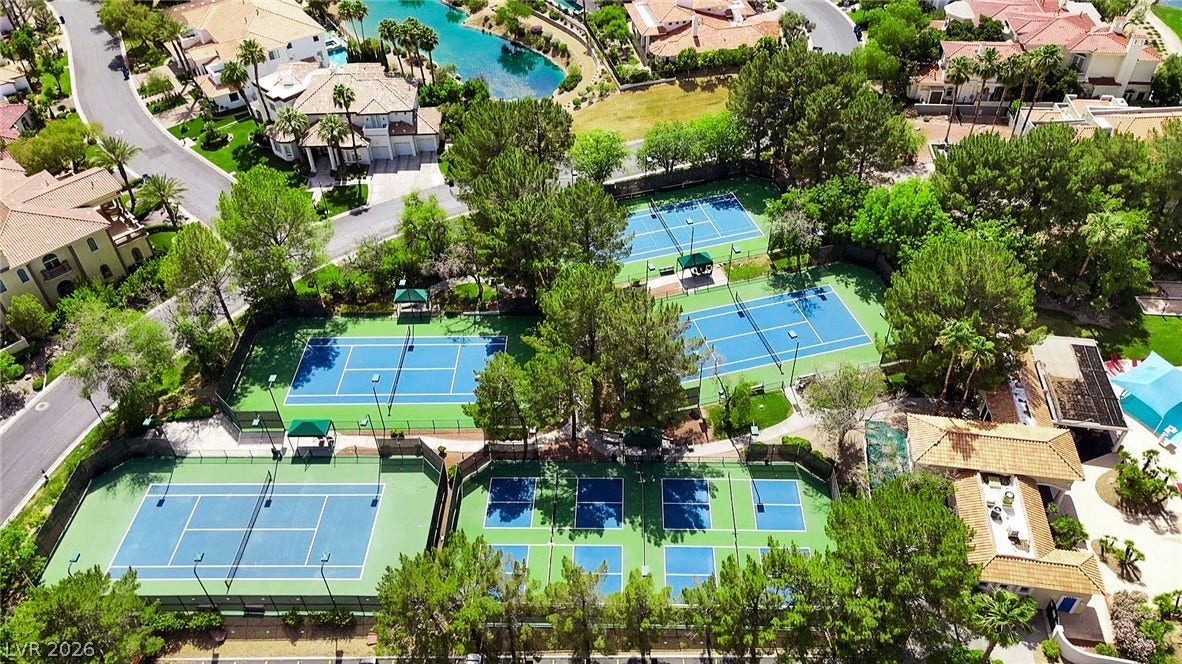 8921 Diamond Falls Drive, Las Vegas, NV 89117 An aerial perspective reveals multiple well-maintained tennis courts nestled within a community.