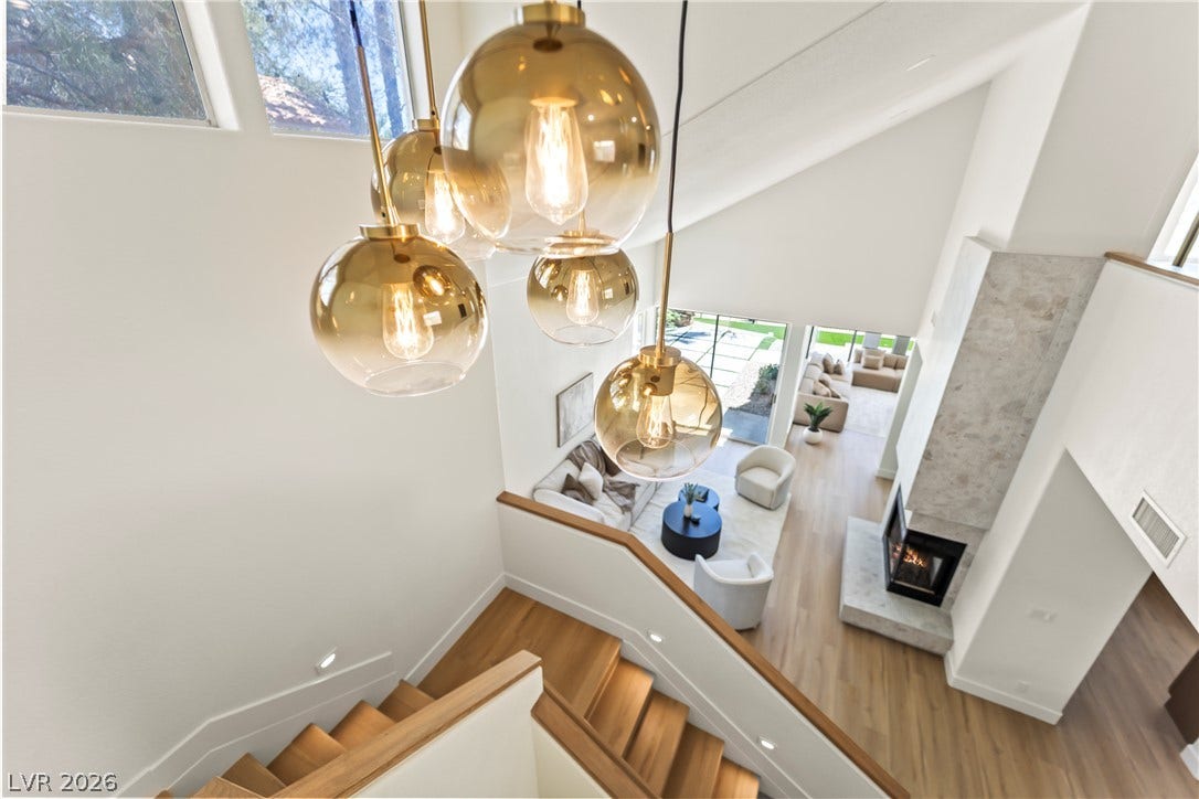 8921 Diamond Falls Drive, Las Vegas, NV 89117 Architectural ceilings and a fireplace create an inviting atmosphere in this open-concept living space.