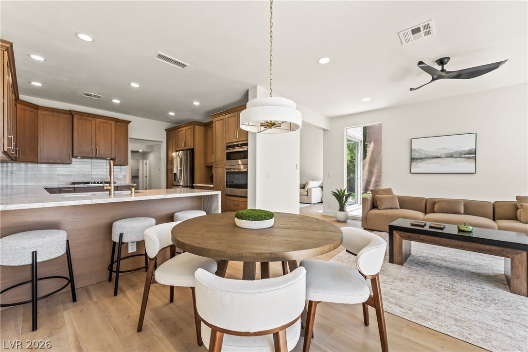 8921 Diamond Falls Drive, Las Vegas, NV 89117 An open concept design seamlessly connects the kitchen and living areas, offering effortless entertaining.