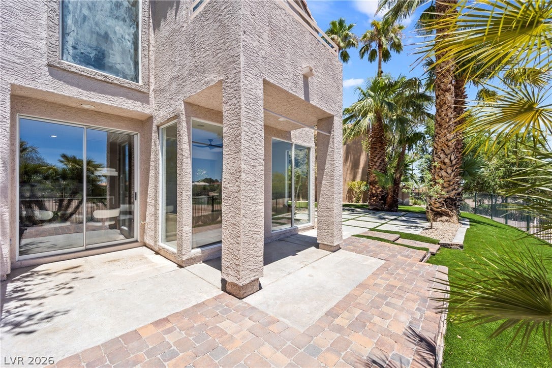 8921 Diamond Falls Drive, Las Vegas, NV 89117 An inviting outdoor patio with pavers and lush green landscaping.