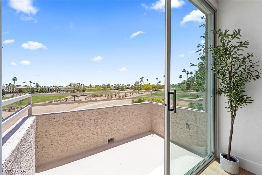 8921 Diamond Falls Drive, Las Vegas, NV 89117 A spacious private patio overlooks the golf course and distant palms, offering serene desert vistas.