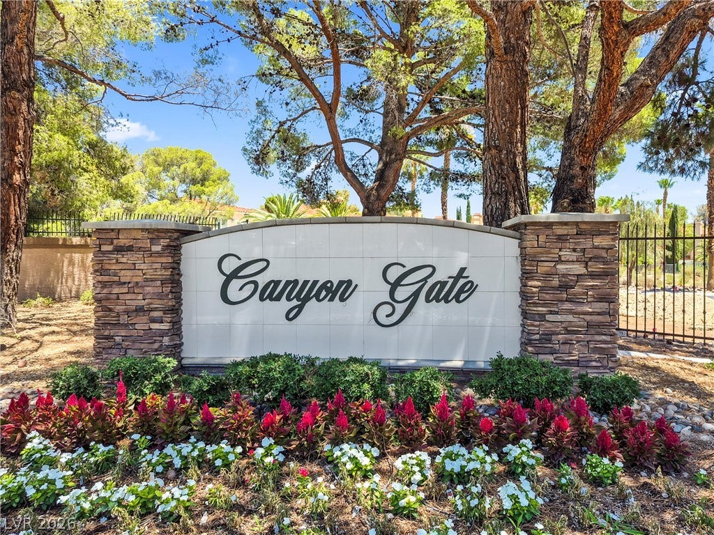 8921 Diamond Falls Drive, Las Vegas, NV 89117 Stone and tile monument sign welcomes residents to the Canyon Gate community.