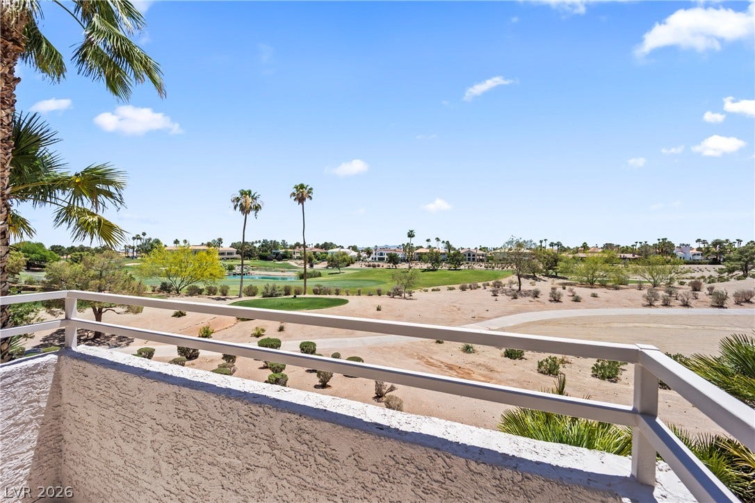 8921 Diamond Falls Drive, Las Vegas, NV 89117 Gaze upon lush golf greens and distant homes from this elevated patio, framed by desert palms.