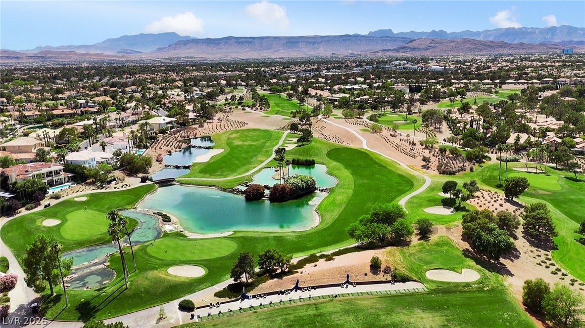 8921 Diamond Falls Drive, Las Vegas, NV 89117 Green fairways and lakes define this premier golf course community, framed by distant mountains.