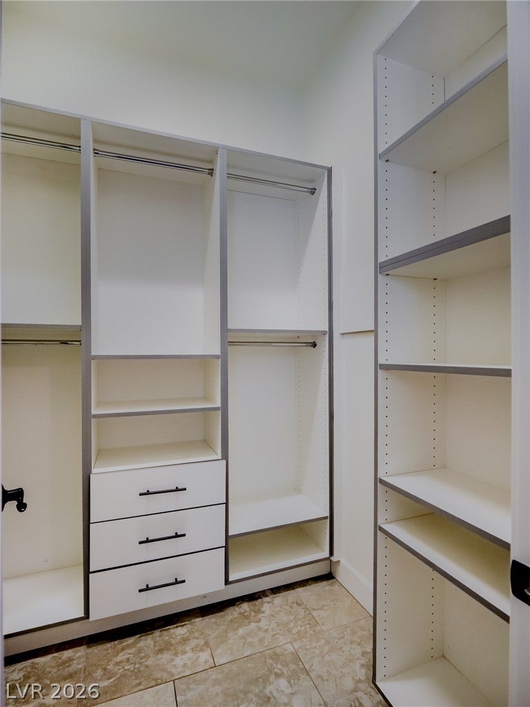 12013 Tramonto Avenue, Las Vegas, NV 89138 Custom built-in shelving and ample drawer storage maximize space in this walk-in closet.