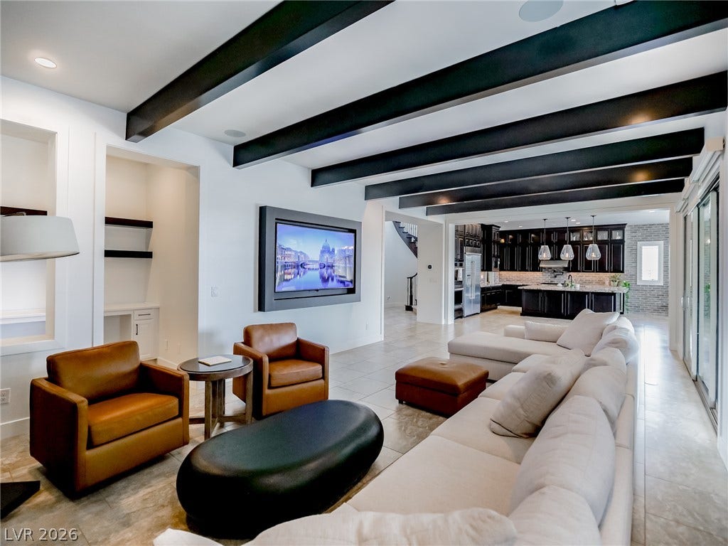 12013 Tramonto Avenue, Las Vegas, NV 89138 Dark exposed ceiling beams stretch across this open living space featuring large-format tile flooring.