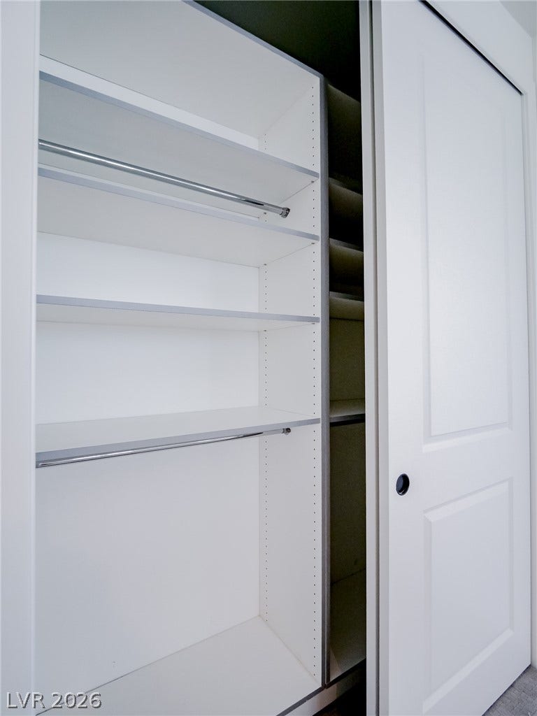 12013 Tramonto Avenue, Las Vegas, NV 89138 Custom shelving and hanging rods maximize storage behind smooth sliding doors.