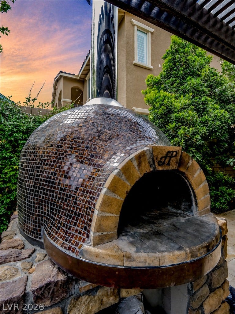 12013 Tramonto Avenue, Las Vegas, NV 89138 A custom mosaic-tiled pizza oven anchors the outdoor entertaining space.