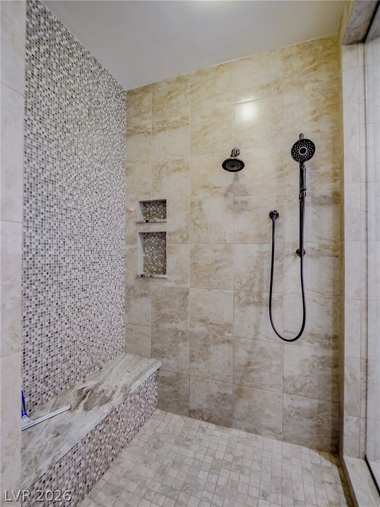 12013 Tramonto Avenue, Las Vegas, NV 89138 Fine tilework surrounds a custom built-in bench in this walk-in shower.