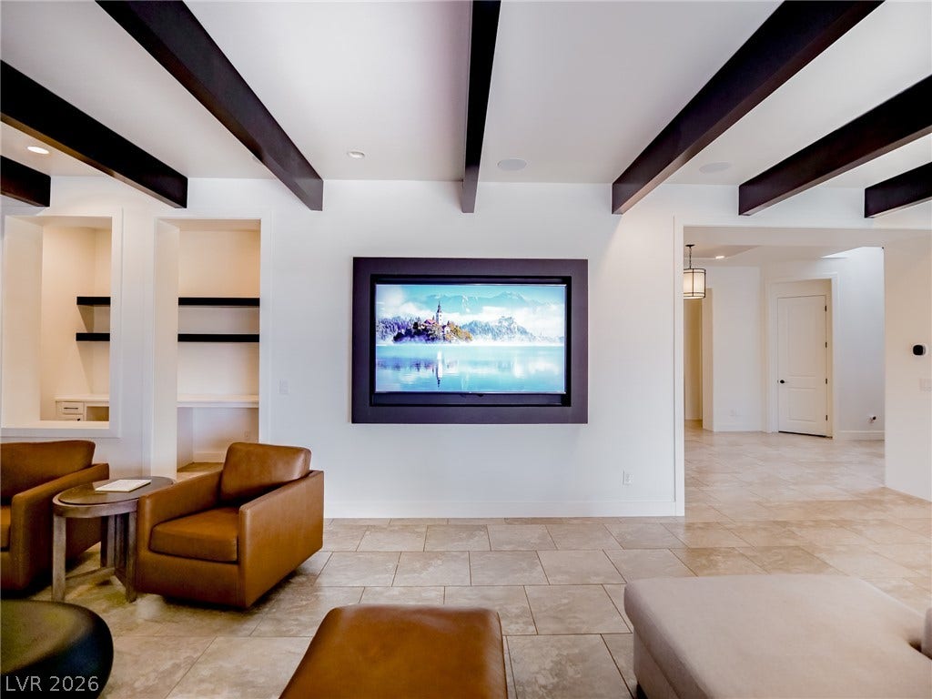 12013 Tramonto Avenue, Las Vegas, NV 89138 Bold ceiling beams and tile flooring define this open living area.