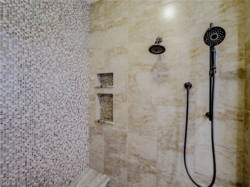 12013 Tramonto Avenue, Las Vegas, NV 89138 Ornate tile walls and dual shower fixtures create a luxurious walk-in shower experience.