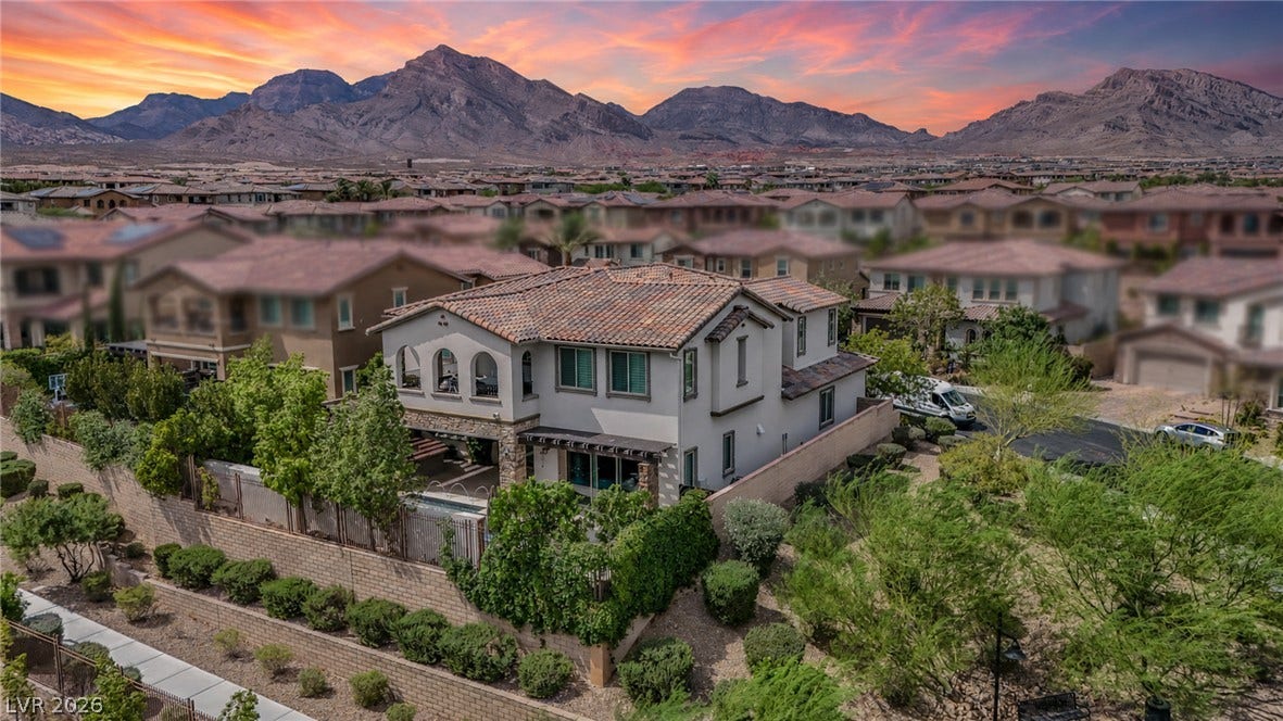 12013 Tramonto Avenue, Las Vegas, NV 89138 Dramatic mountain ridges frame this Mediterranean-style residence nestled in a premier hillside neighborhood.