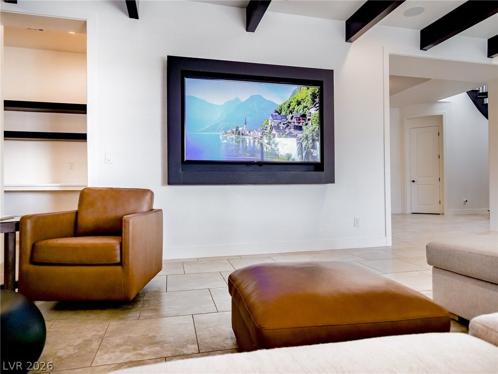 12013 Tramonto Avenue, Las Vegas, NV 89138 Exposed ceiling beams and polished tile flooring define this open contemporary living space.
