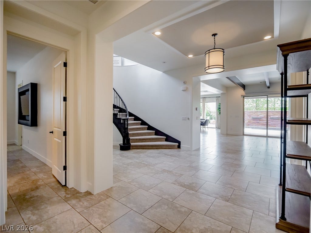 12013 Tramonto Avenue, Las Vegas, NV 89138 An open entryway flows seamlessly into light-filled living spaces detailed with refined tile flooring.